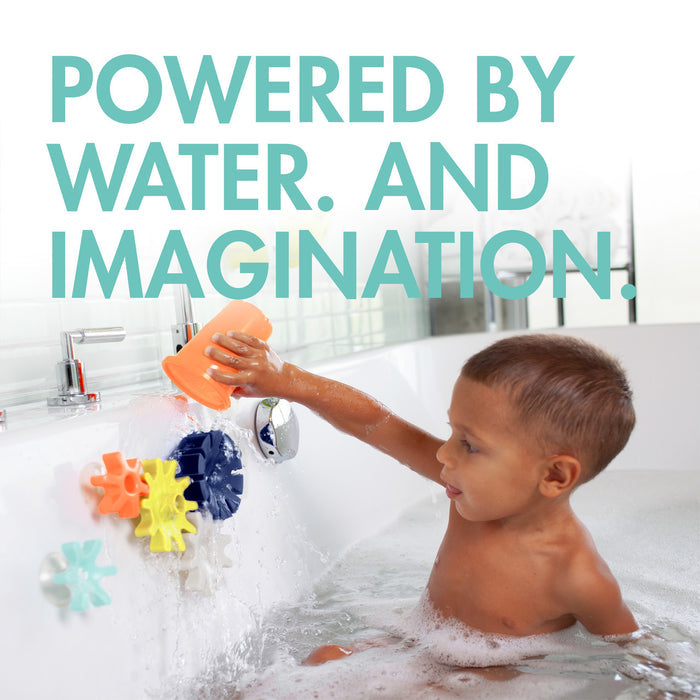 Little boy plays with Boon COGS Building Bath Toy Set - Navy / Yellow