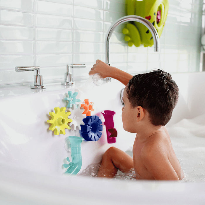 Little boy plays with Boon COGS Building Bath Toy Set - Navy / Yellow