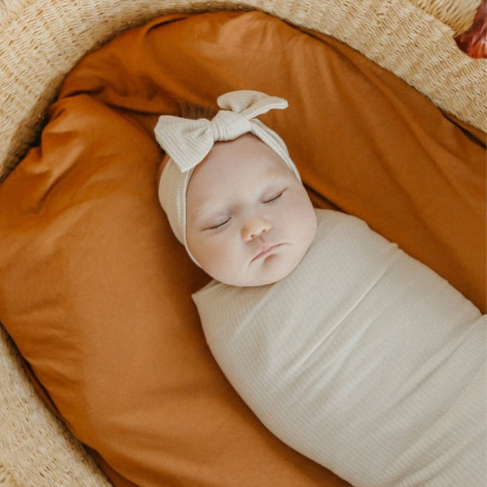 Baby wearing Copper Pearl Rib Knit Headband Bow - Moonstone