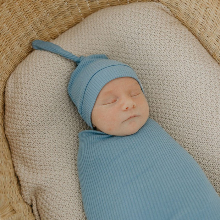 Baby wearing Copper Pearl Rib Knit Top Knot Hat - 0-4M - Atlantic