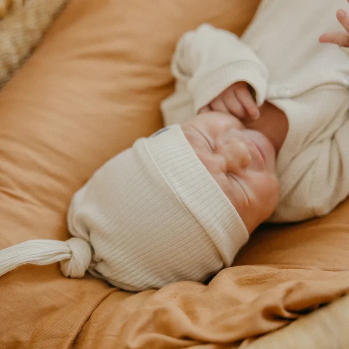 baby wearing Copper Pearl Rib Knit Top Knot Hat - 0-4M - Moonstone