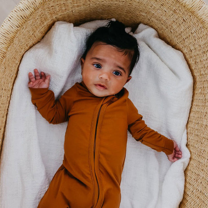 Baby wearing Copper Pearl Zip-up Footie - Camel