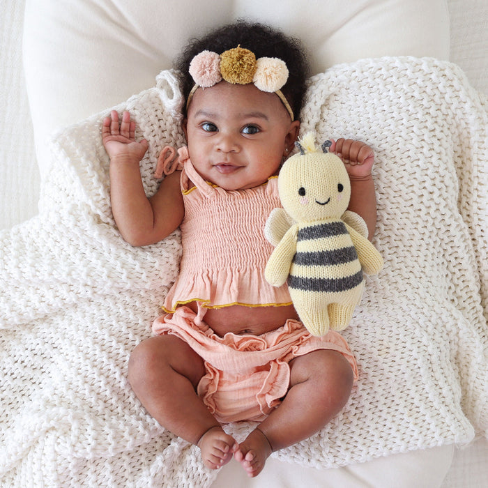 Baby girl holding Cuddle and Kind Baby Bee - Yellow