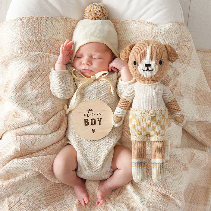 Newborn baby lying next to Cuddle and Kind George the Dog - little 13"