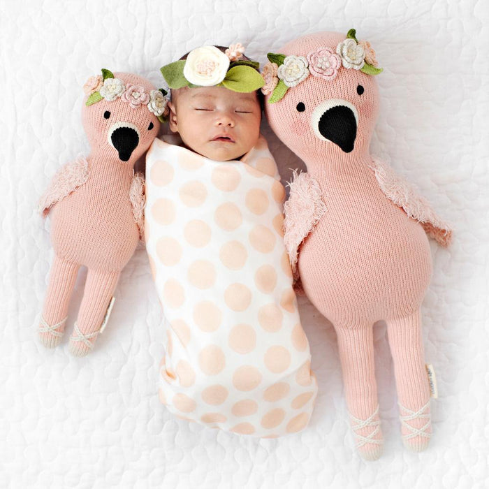 Newborn baby sleeping next to Cuddle and Kind Penelope the Flamingo