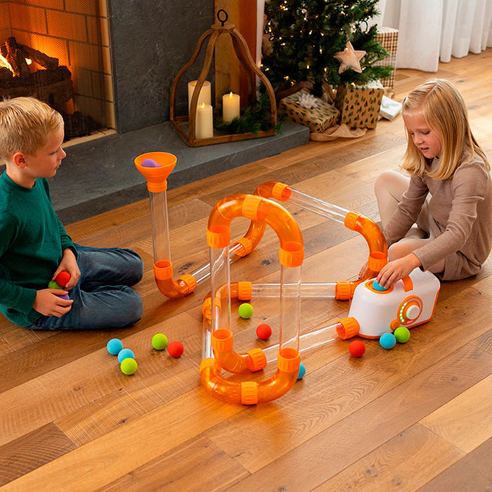 Two kids play with Fat Brain Toys Air Toobz Extension Set
