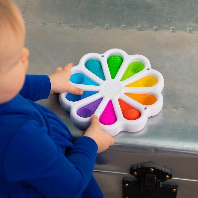 Child Playing with Fat Brain Toys Dimpl Digits