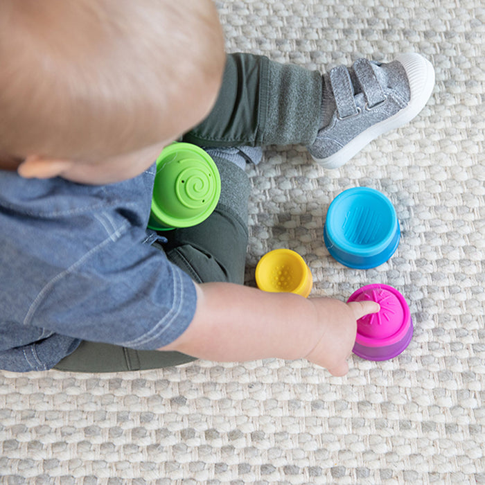Toddler playing with Fat Brain Toys Dimpl Stack