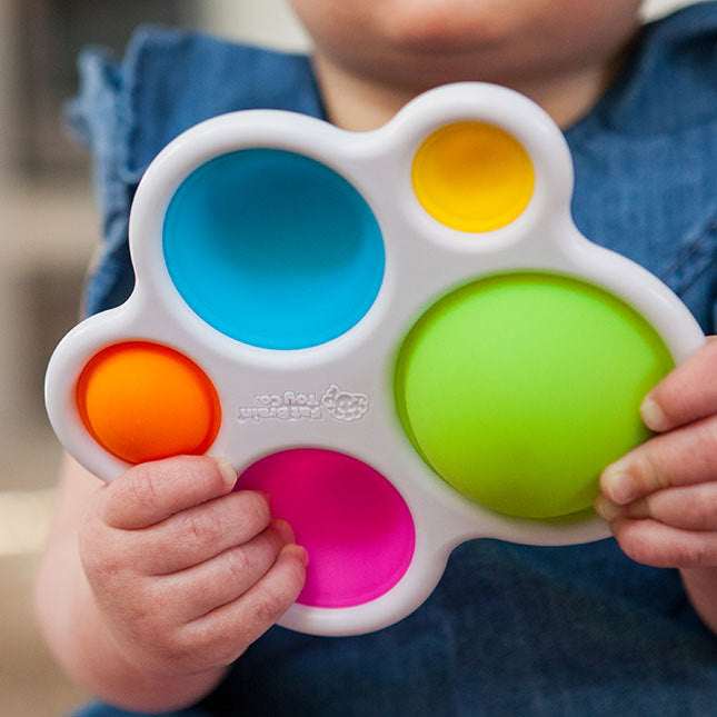 Child Playing with Fat Brain Toys Dimpl