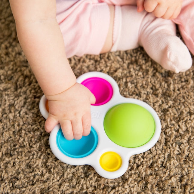Child Playing with Fat Brain Toys Dimpl