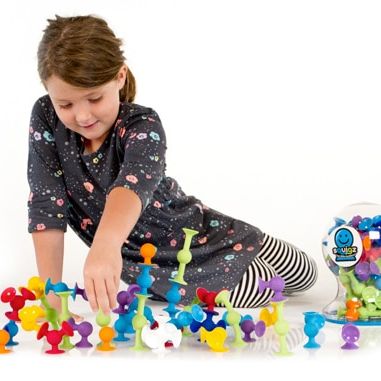 Child Playing with Fat Brain Toys Squigz Deluxe Toy Set