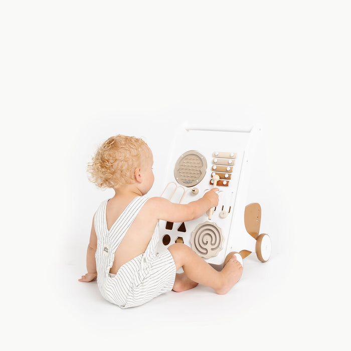 Toddler plays with xylophone on Gathre Activity Walker