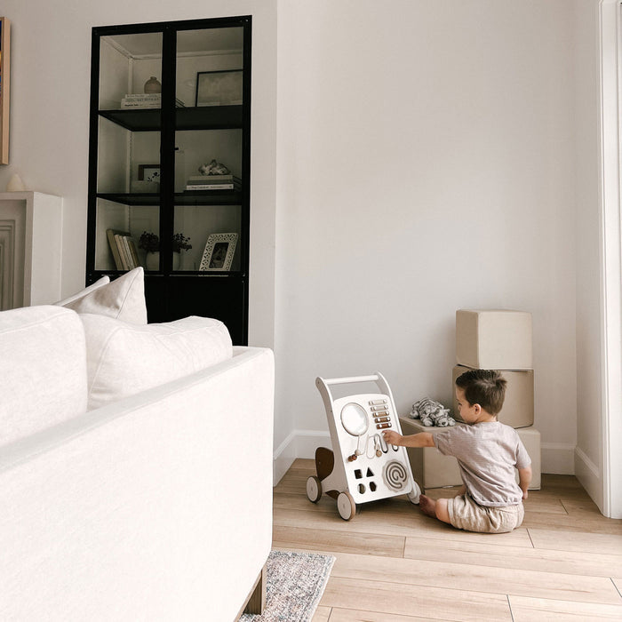 Child sits and plays with Gathre Activity Walker