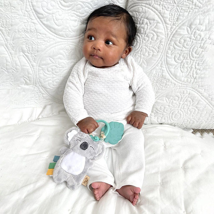 Baby Holding Itzy Ritzy Itzy Pal Infant Toy - Kayden the Koala