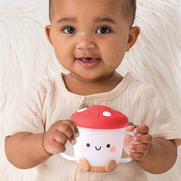 Toddler holding Itzy Ritzy Itzy Snack Cup - Ash the Mushroom