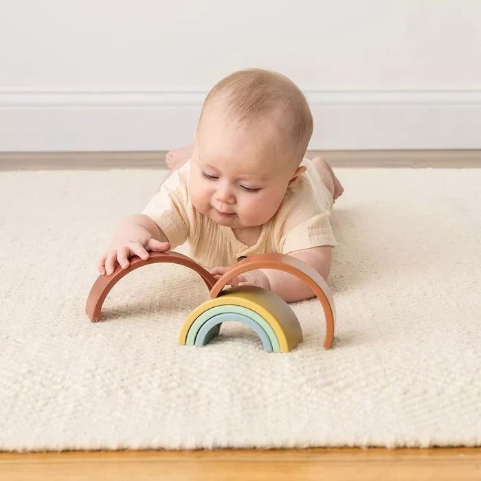 Baby plays with Itzy Ritzy Ritzy Rainbow Stacking Toy