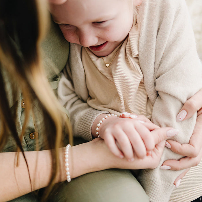Little girl and mom wearing matching Joyful Bead Company Fancy Pearl Bracelet