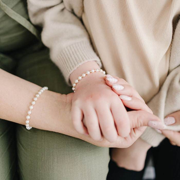 Little girl and mom wearing matching Joyful Bead Company Fancy Pearl Bracelet