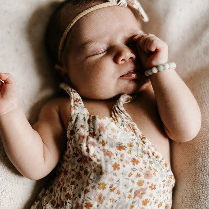 Newborn baby girl wearing Joyful Bead Company Frosted Blaire Bracelet