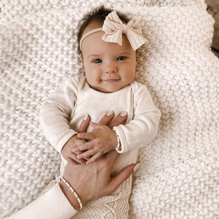 Baby and mom wearing matching Joyful Bead Company Goldie Dot Bracelet