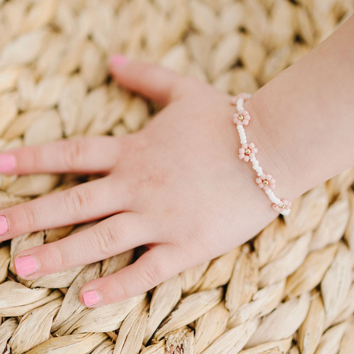 Little girl wears Joyful Bead Company Petal Pink Flower Bracelet - Gold