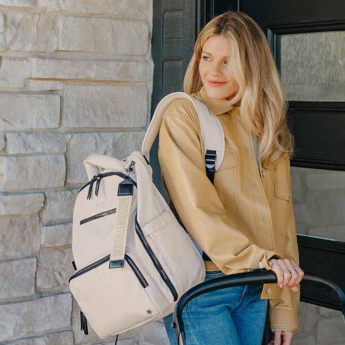 Witney carson pushing stroller with JuJuBe Classic Backpack - Witney Carson - Cloud on her back