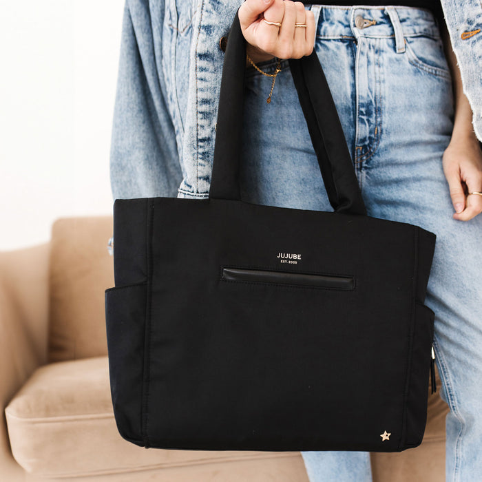 Woman holding JuJuBe Utility-Strap Tote - Black
