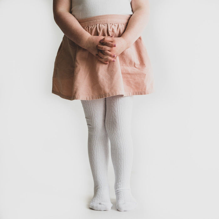 Little girl wearing Little Stocking Co Cable Knit Tights - White