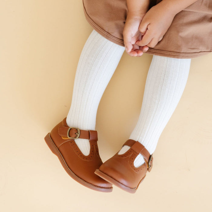 Little girl wearing Little Stocking Co Ribbed Knit Tights - Ivory