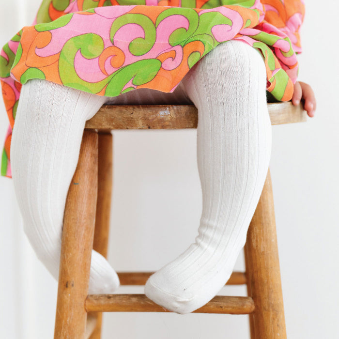 Little girl wearing Little Stocking Co Ribbed Knit Tights - Ivory