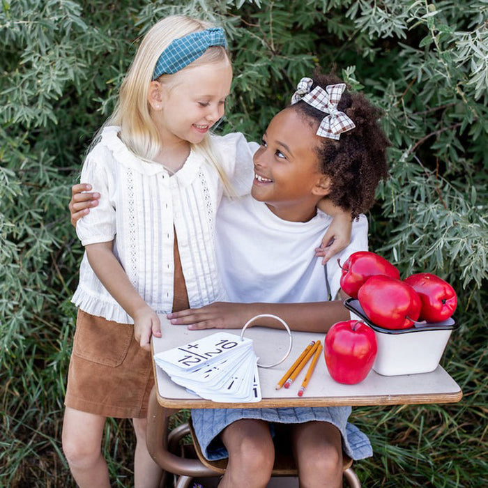 Little girl wearing two Modern Piggy Ribbon Bow - Alligator Clip - Schoolgirl Plaid hugs friend
