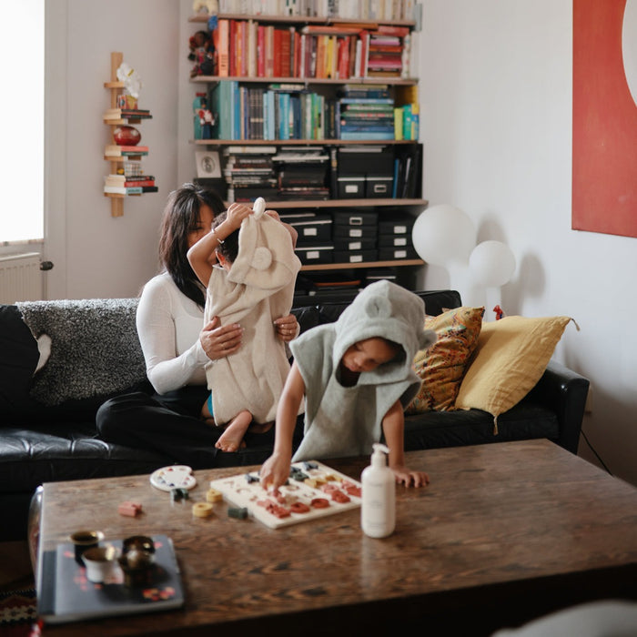 Children wearing Mushie Bear Poncho Towel