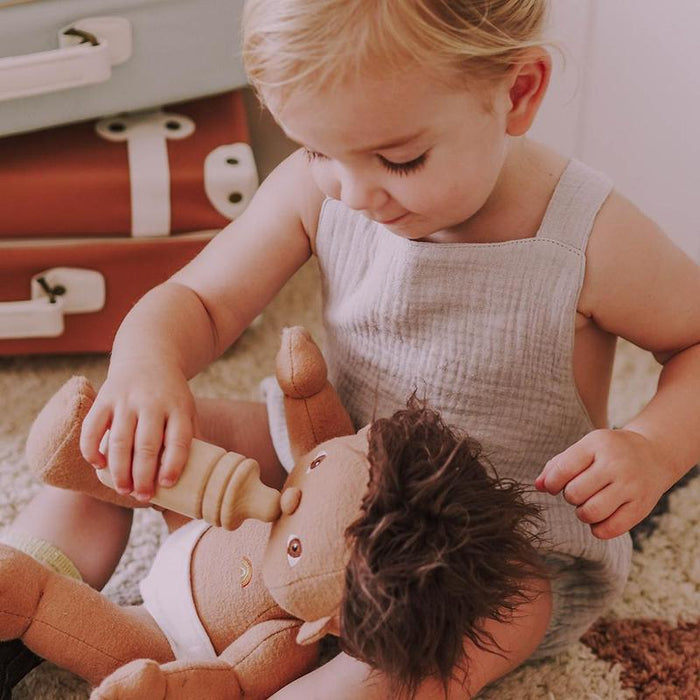 Baby playing with Olli Ella Dinkum Doll Bottle