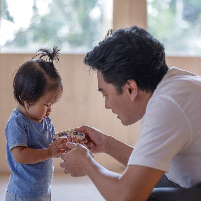 Father and Daughter playing with PlanToys My First Phone - Orchard Series