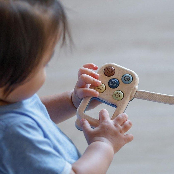 Toddler Playing with PlanToys My First Phone - Orchard Series