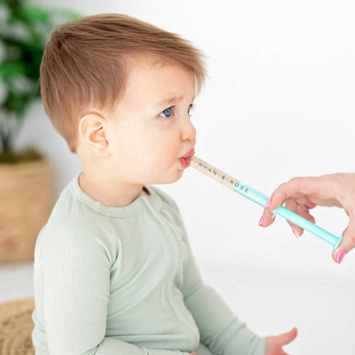 Mom gives baby medicine using Ryan and Rose Cutie Dose - Oral Liquid Dispenser - Lollipop