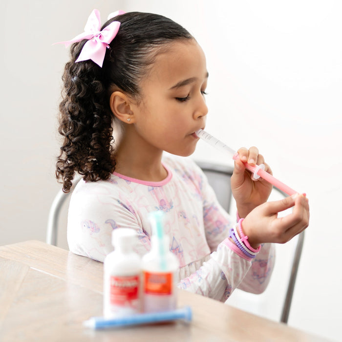 Girl takes medicine with Ryan and Rose Cutie Dose - Oral Liquid Dispenser - Lollipop