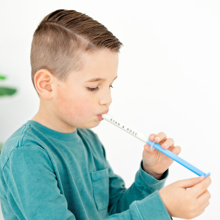 Little boy using Ryan and Rose Cutie Dose - Oral Liquid Dispenser - Lollipop