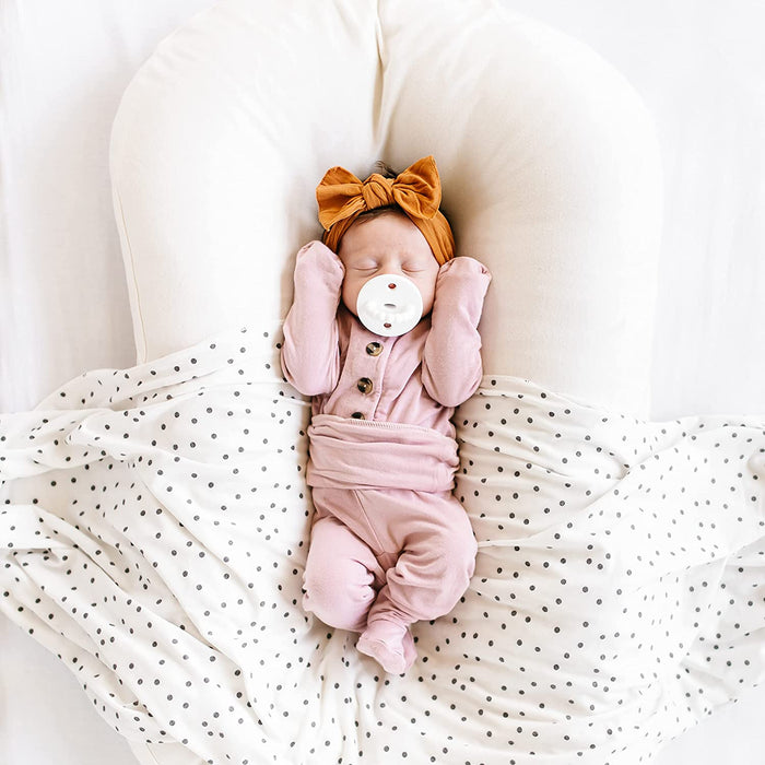 Newborn sleeping while sucking on Ryan and Rose Cutie PAT Kit - Neutral Kit