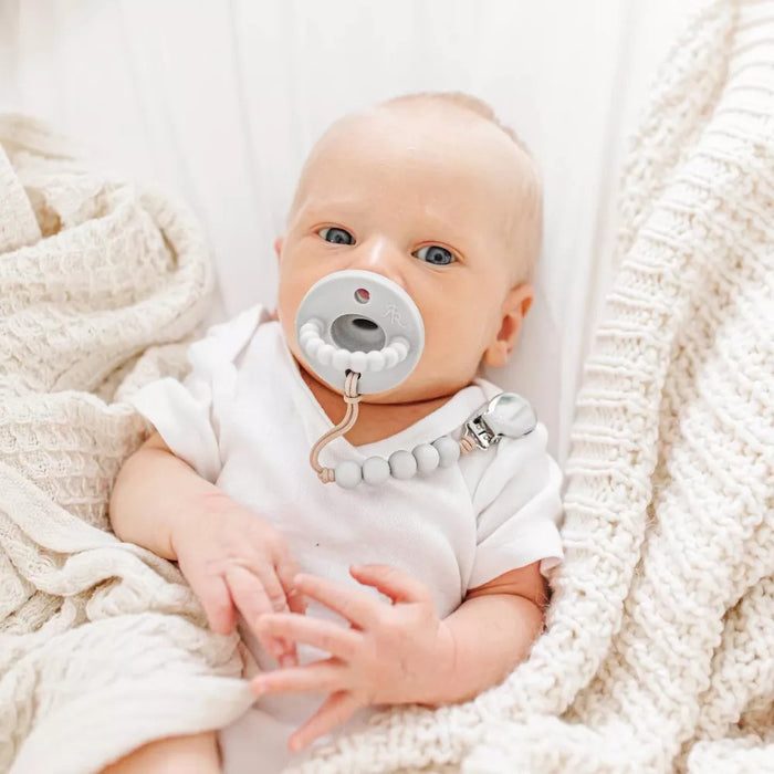 Baby sucks on Ryan and Rose Flat Cutie PAT Pacifier 2 Pack - Grey / White