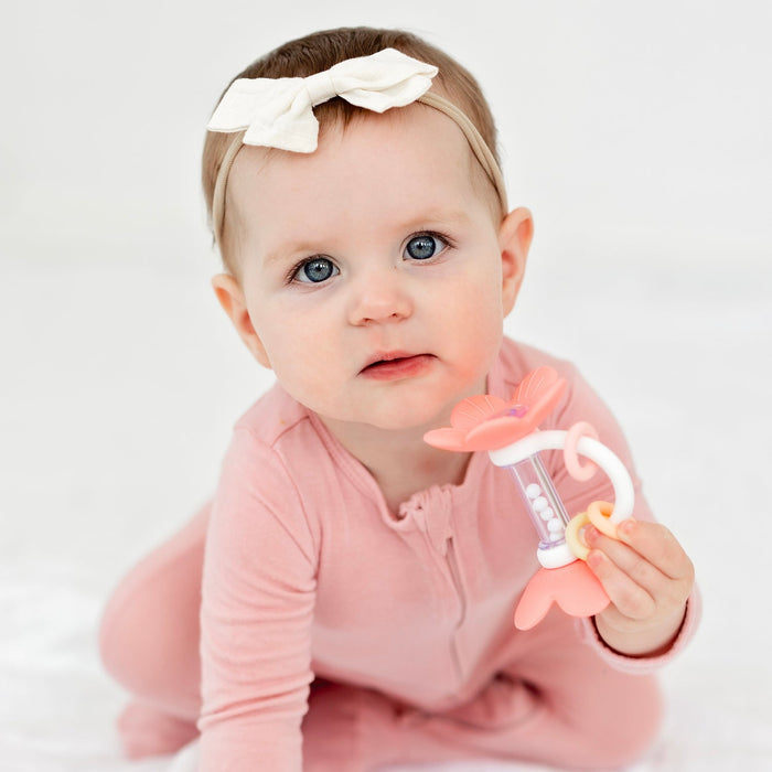 Baby girl plays with Ryan and Rose Flower Teether Rattle Toy - Shortcake