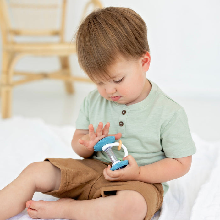 Little boy plays with Ryan and Rose Gear Teether Rattle Toy - Oxford