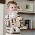 Child hugs Saranoni Stuffed Animal - Bear