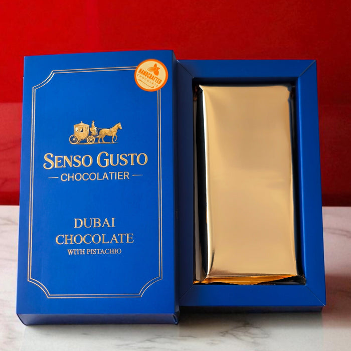 Blue Senso Gusto Premium Dubai chocolate box with a gold chocolate bar on a red background