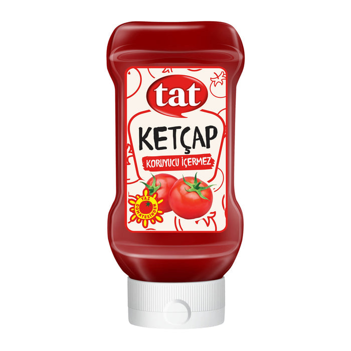 A bottle of Tat Ketchup with a label showing the brand name 'Tat' and the product name 'KETCAP' in bold letters, along with a picture of a tomato and some decorative elements.