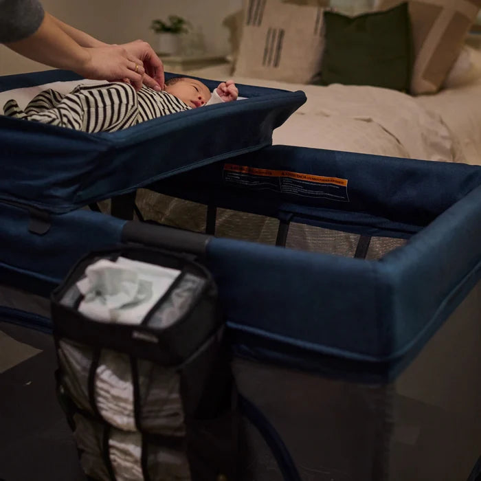 Baby in bassinet with UPPAbaby Changing Station Organizer - REMI