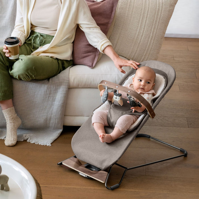 Baby sitting in Mira Bouncer with UPPAbaby Forest Fun Toy Bar - MIRA accessory attached