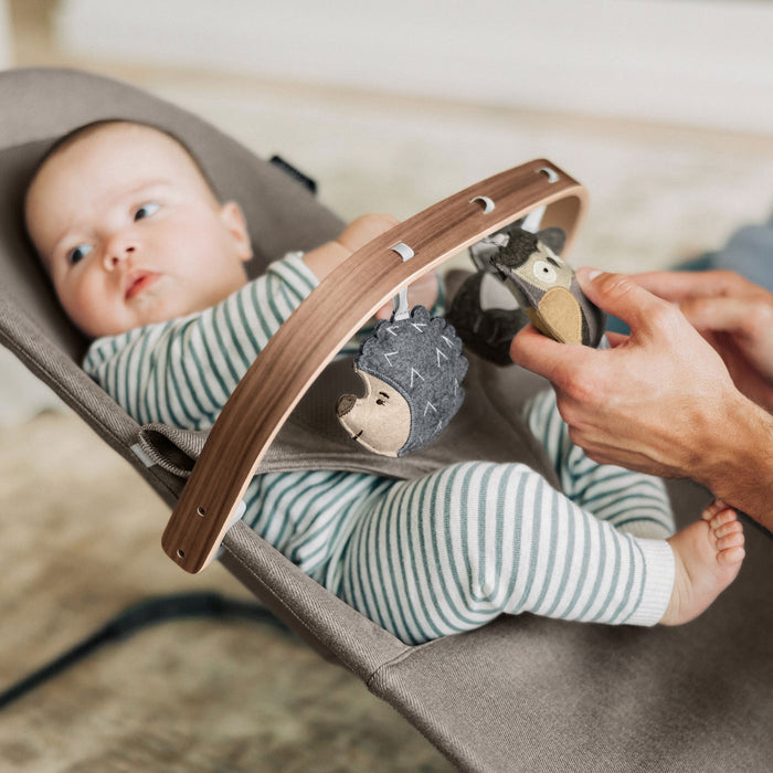Baby sitting in Mira Bouncer with UPPAbaby Forest Fun Toy Bar - MIRA accessory attached