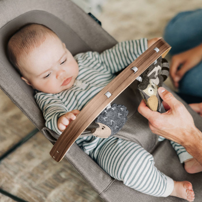 Baby sitting in Mira Bouncer with UPPAbaby Forest Fun Toy Bar - MIRA accessory attached