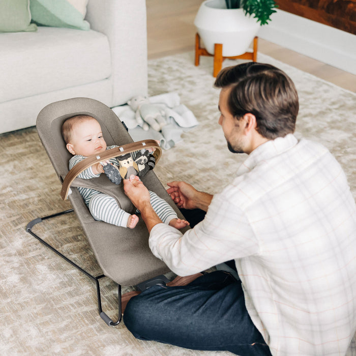Baby sitting in Mira Bouncer with UPPAbaby Forest Fun Toy Bar - MIRA accessory attached